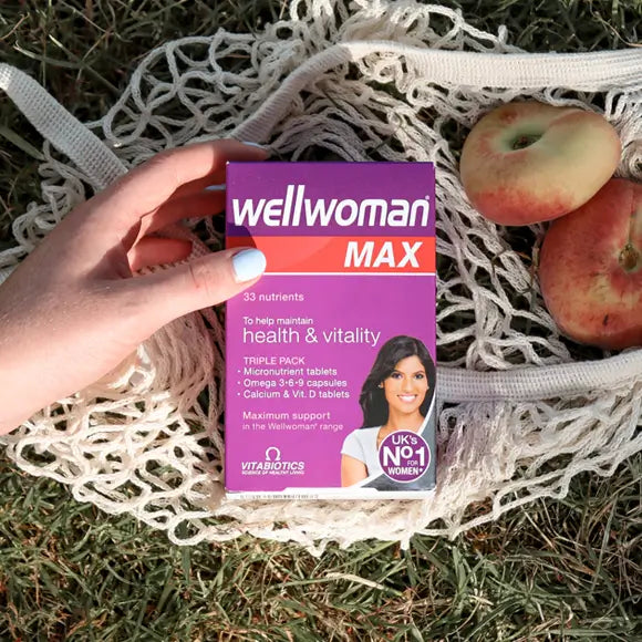 wellwoman Max Tabletrs Box in the hands of a girl near picnic basket