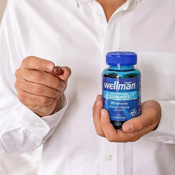 Wellman Multivitamin Gummies - A tablet in an oldman's hand